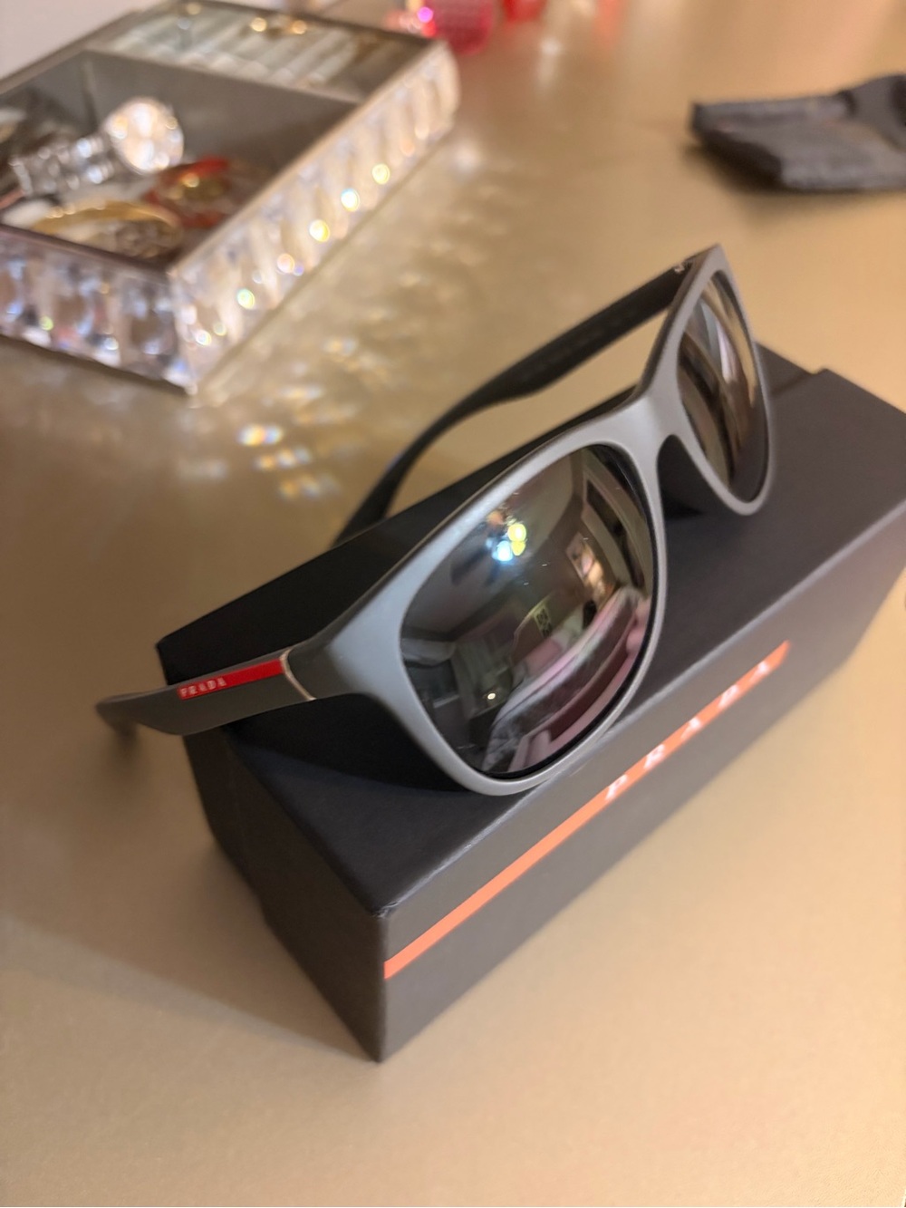 Prada Men's Gray Sunglasses with Red Temple Stripe